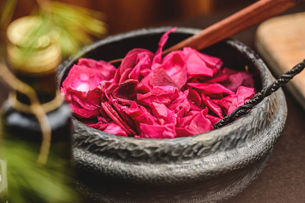 Pink rose petals and dried hawthorn leaves in a ceramic bowl